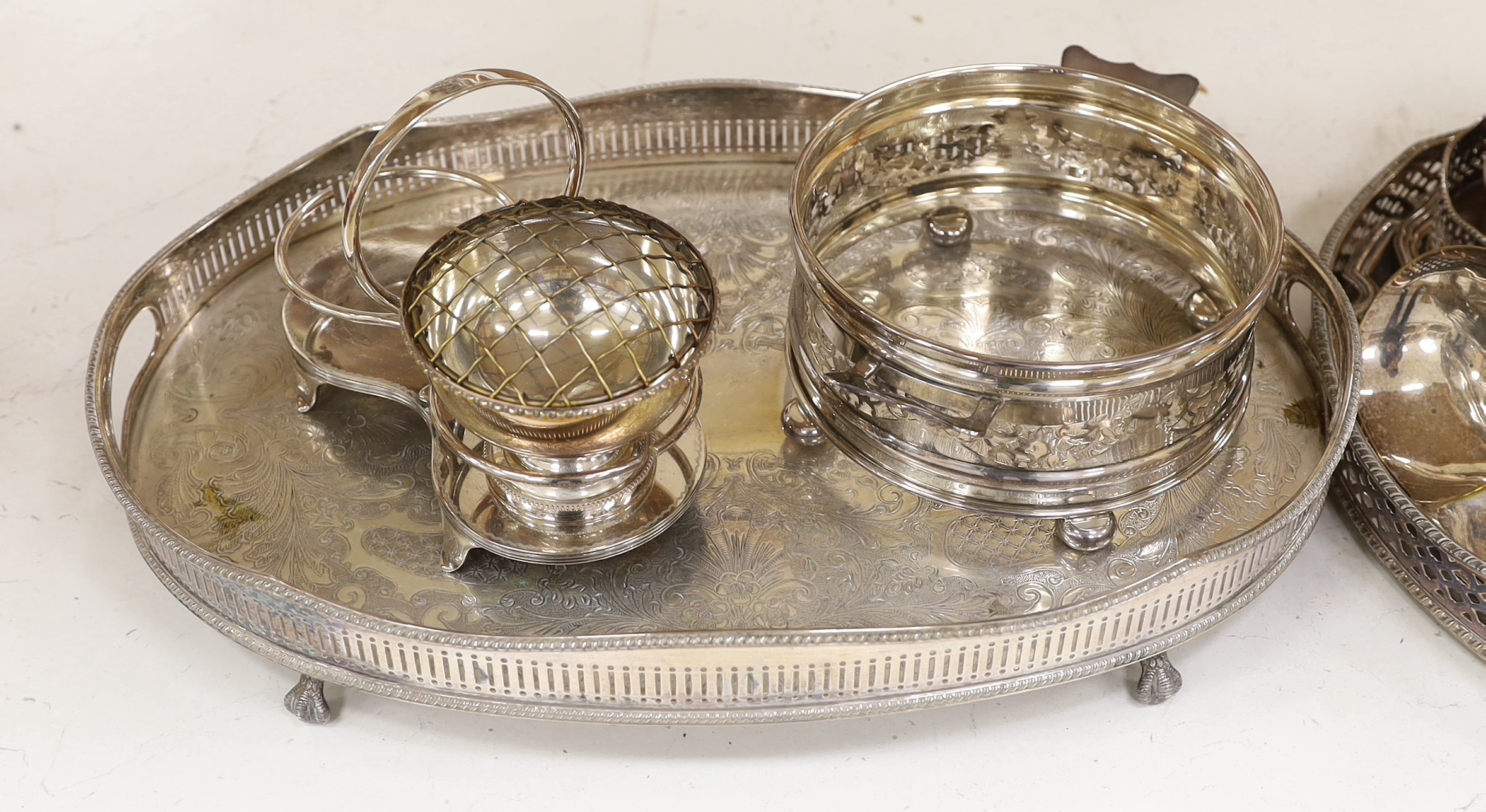 A quantity of silver plate including two trays with pierced galleries, a wine coaster, condiment serving pots, etc.